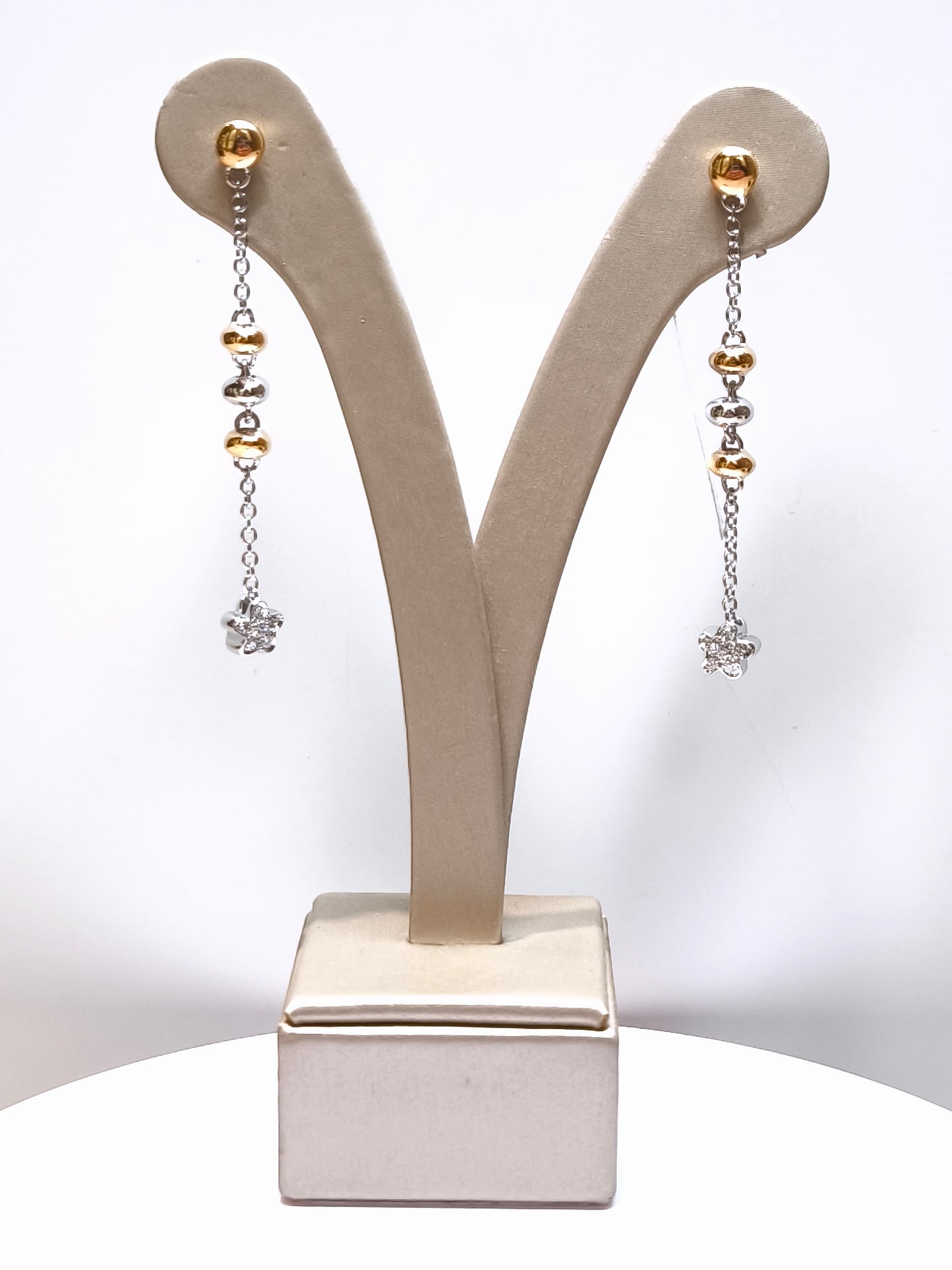 Gold earrings and dangling diamonds