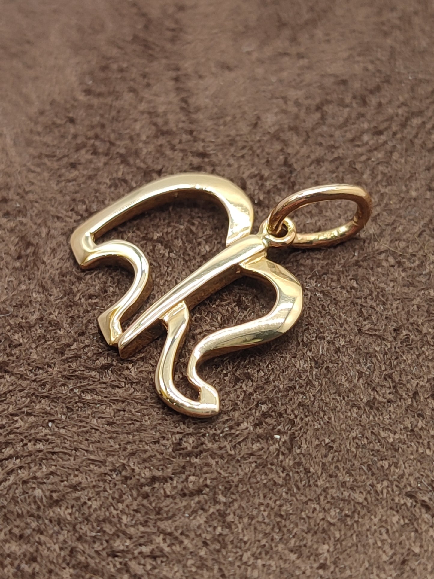 Gold perforated elephant pendant