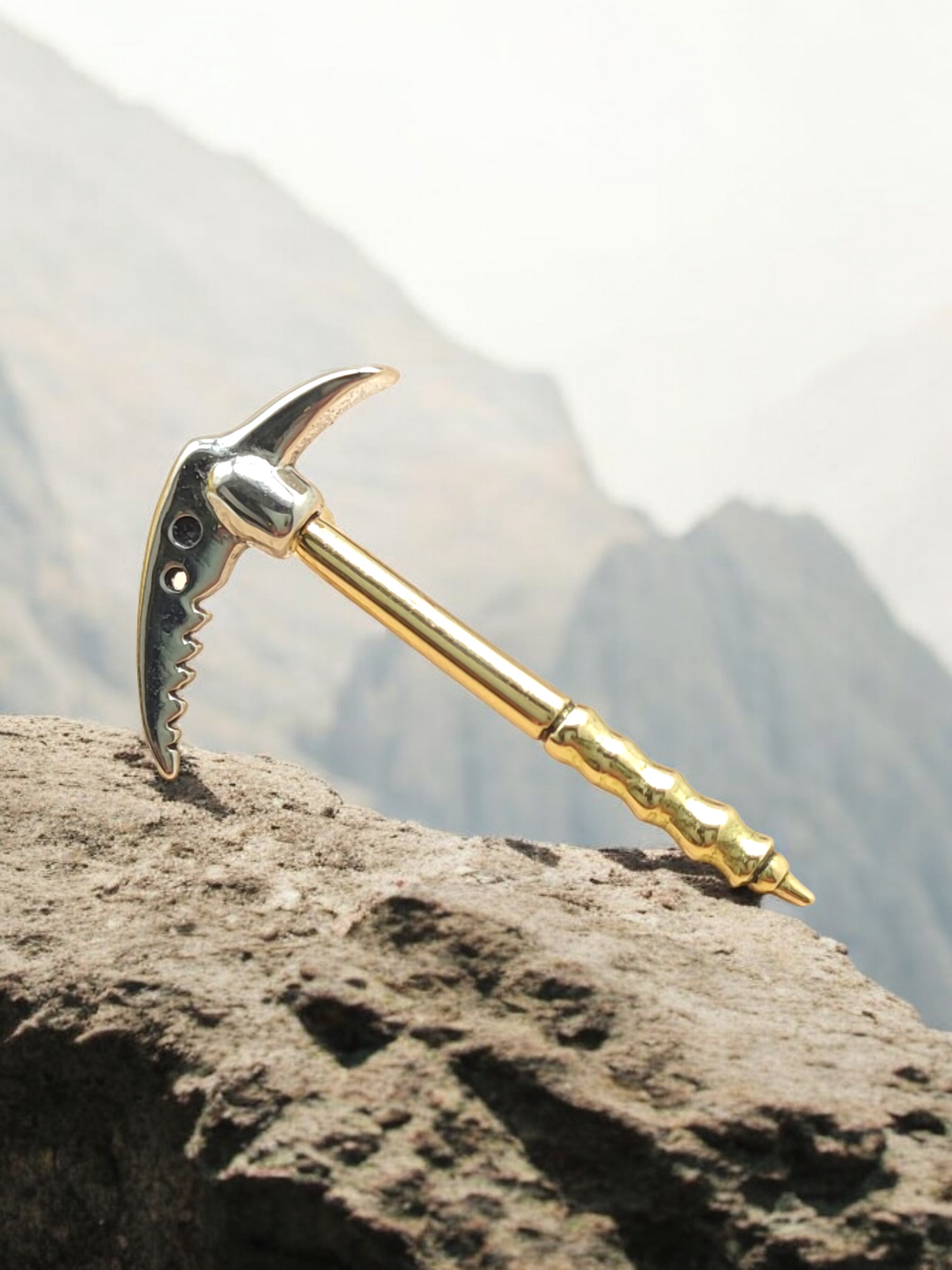 Gold tip in the shape of an Alpine ice axe