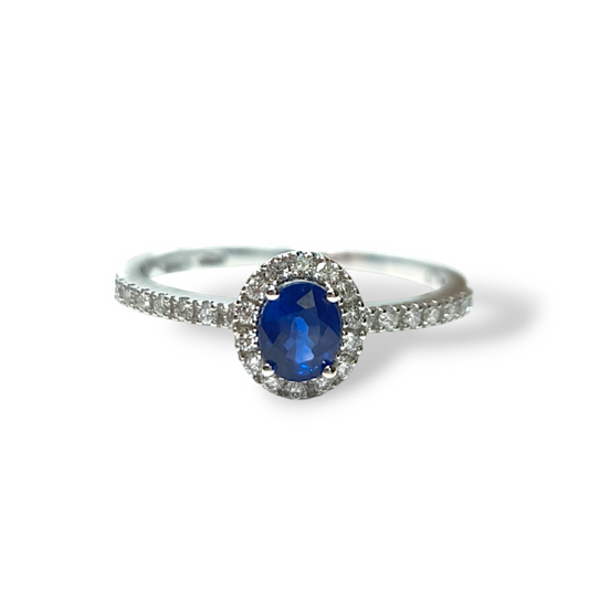 Gold solitaire ring with sapphire and diamonds