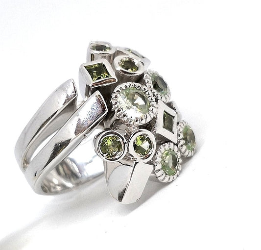 Silver ring with green zircons