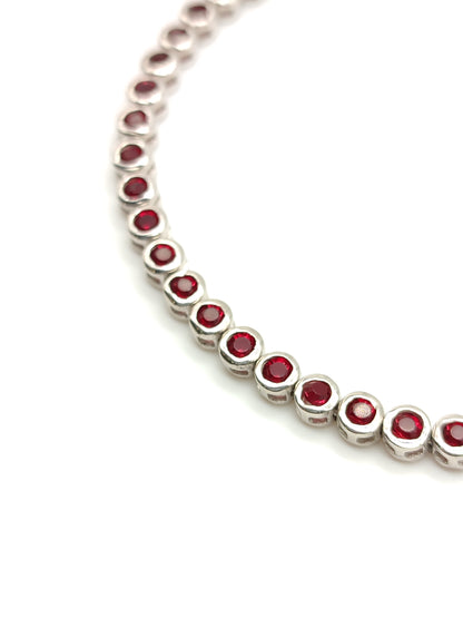 Silver tennis bracelet with red zircons