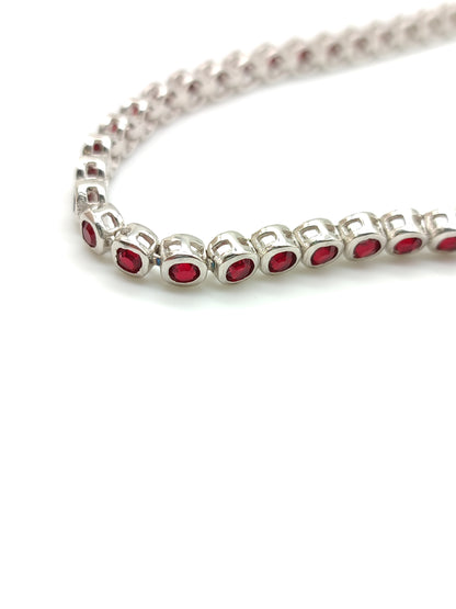 Silver tennis bracelet with red zircons