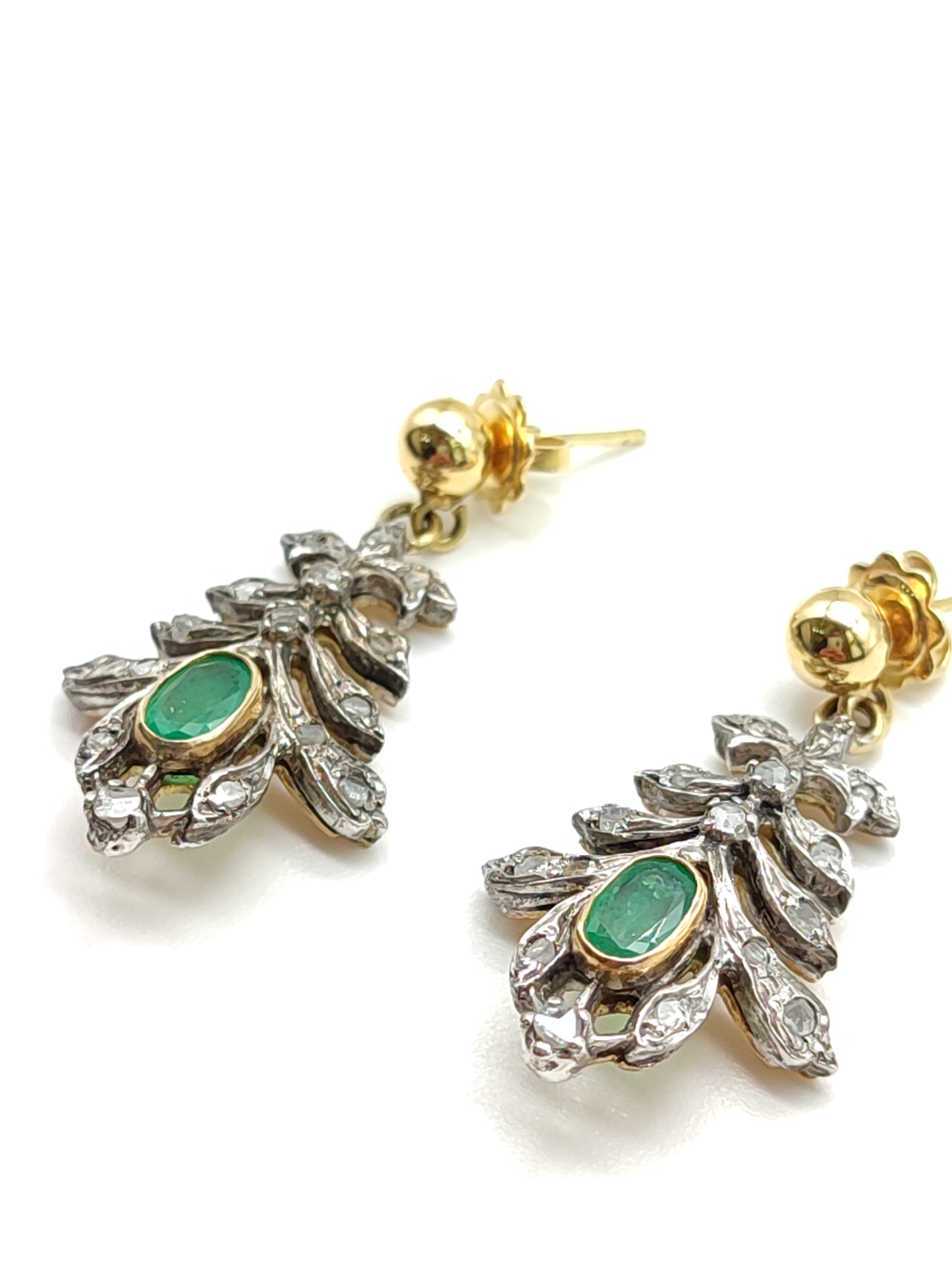 Silver and gold earrings with diamonds and emeralds