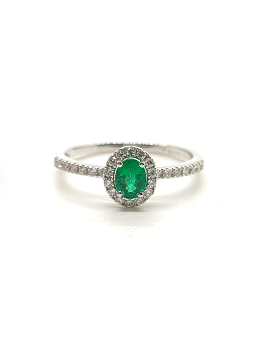 Gold solitaire ring with emerald and diamonds