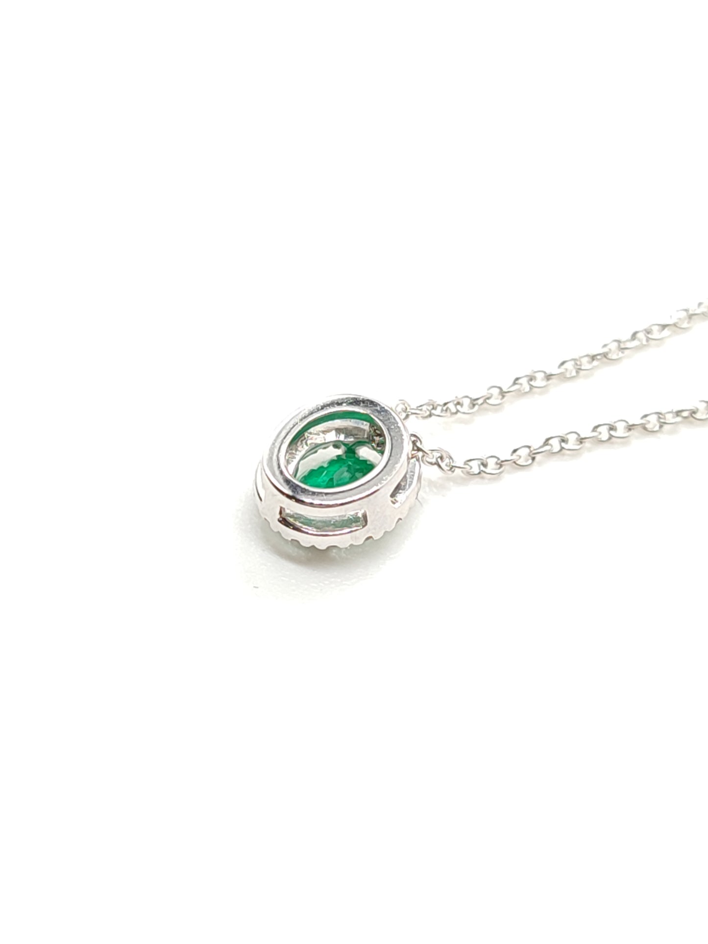 White gold necklace with emerald