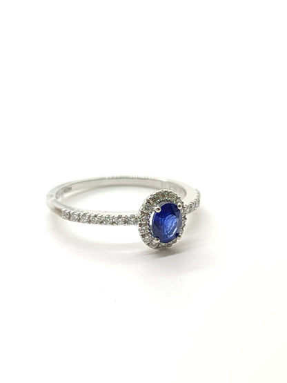 Gold solitaire ring with sapphire and diamonds