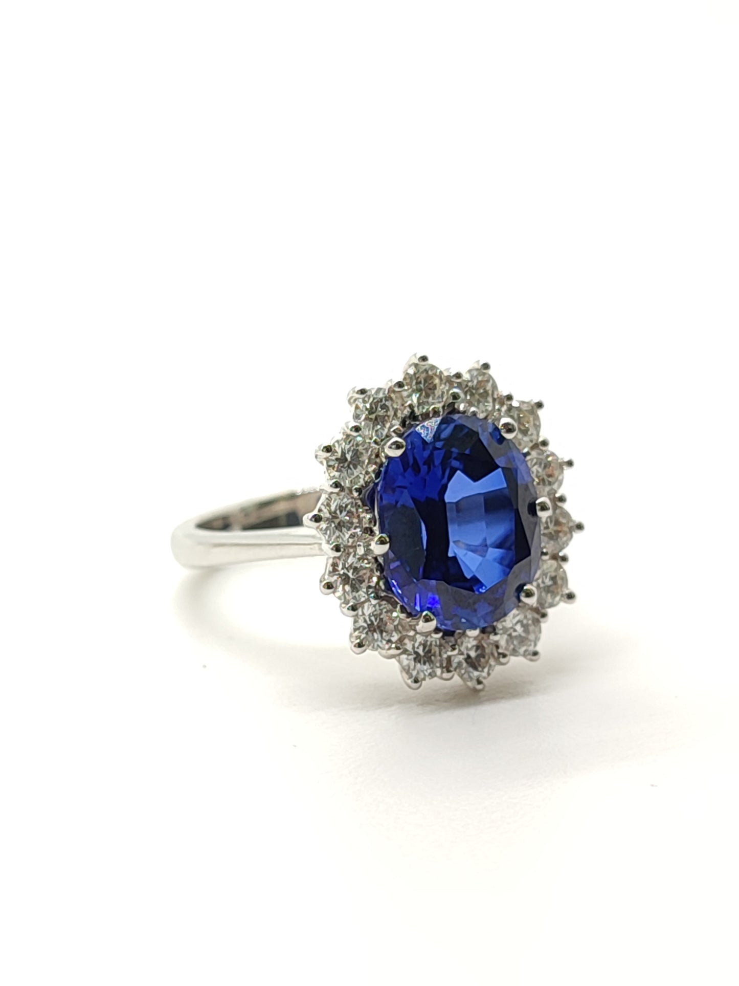 Gold solitaire ring with created sapphire and diamonds
