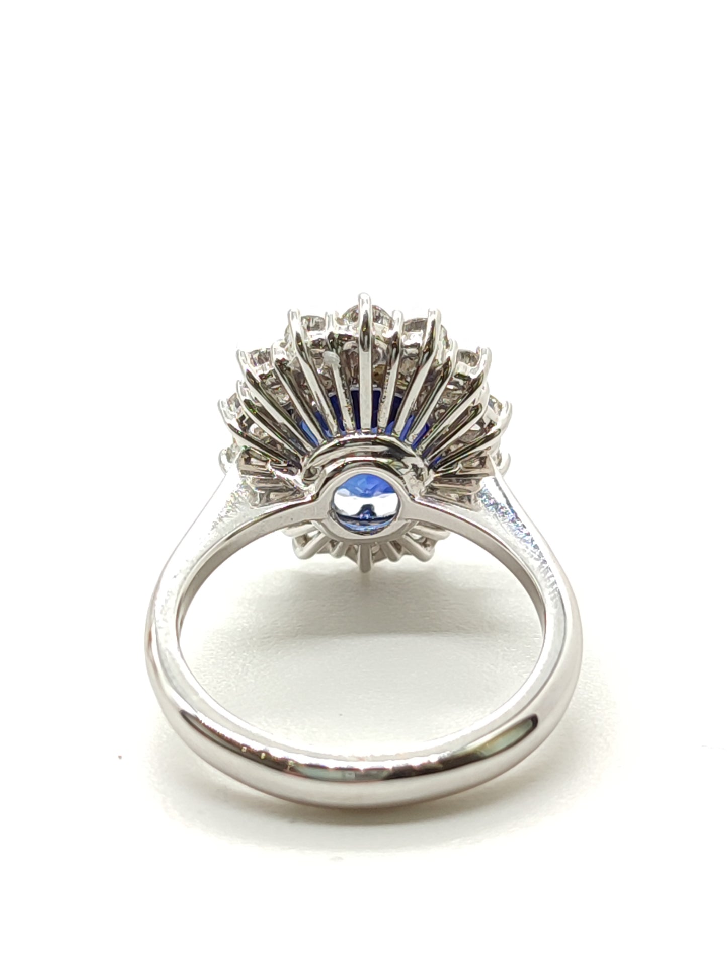 Gold solitaire ring with created sapphire and diamonds