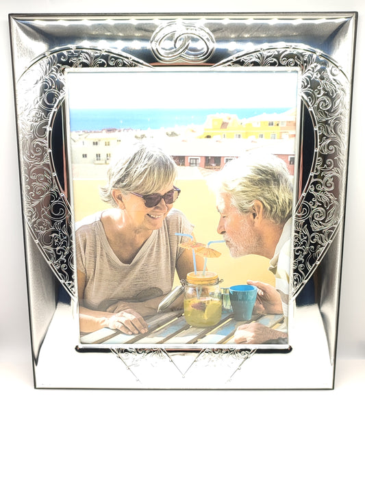 Silver photo frame Sequences of wedding rings with worked heart 20x25cm