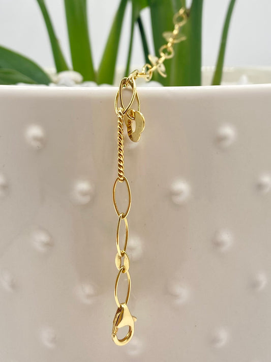 Yellow gold bracelet with ovals and small flowers